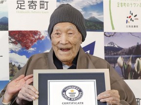 In this April 10, 2018, file photo, Masazo Nonaka eats a cake after receiving the certificate from Guinness World Records as the world's oldest living man at then age 112 years and 259 days during a ceremony in Ashoro on Japan's northern main island of Hokkaido. In the early hours of Sunday, Jan. 20, 2019, Nonaka died at his home _ a hot springs inn _ in northern Japan at the age of 113. (Masanori Takei/Kyodo News via AP) ORG XMIT: BKWS802