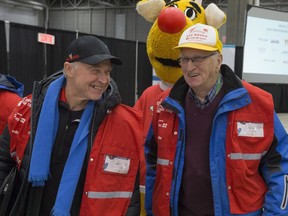 Opération Nez Rouge founder Jean-Marie De Koninck, left, and longtime volunteer Claude Albert leave the service's Quebec City headquarters to bring home someone who is too drunk to drive on Thursday December 13, 2018.