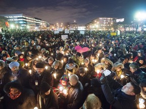 People attend a vigil for victims of the mosque shooting in Quebec City Monday, January 30, 2017 in Montreal. "It would be wonderful if we did not wait for a tragedy to unite us and to reach out to those who look or think differently than we do," Fariha Naqvi-Mohamed writes.