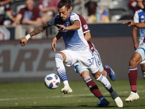FC Dallas forward Maximiliano Urruti, front, moves the ball past Colorado Rapids midfielder Cole Bassett on Oct. 28, 2018, in Commerce City, Colo. The Montreal Impact acquired Argentine striker Urruti from FC Dallas in exchange for US$75,000 in targeted allocation money and a first-round pick in the 2019 MLS SuperDraft.