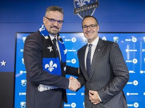 Montreal Impact owner Joey Saputo, right, shakes hands Kevin Gilmore following a news conference in Montreal, Tuesday, January 22, 2019, announcing Gilmore as the new President and CEO of the MLS soccer club.