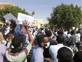 FILE - In this Dec. 25, 2018 file handout photo provided a Sudanese activist, people chant slogans during a demonstration in Khartoum, Sudan. The anti-government protests rocking Sudan for the past month are reminiscent of the Arab Spring uprisings of nearly a decade ago. Demonstrators, many in their 20s and 30s, are trying to remove President Omar al-Bashir, an authoritarian leader, and win freedoms and human rights. (Sudanese Activist via AP, File) ORG XMIT: SUD502