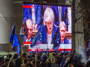 People’s Vote supporters watch the Parliamentary debate live in Parliament Square ahead of Theresa May's Brexit withdrawal plan.