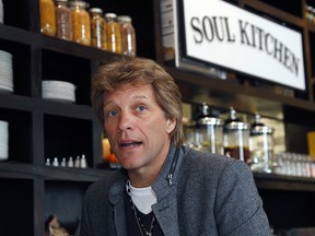 In this Oct. 19, 2011, file photo, rock star Jon Bon Jovi sits in his JBJ Soul Kitchen community restaurant in Red Bank, N.J. (AP Photo/Wayne Parry, File)