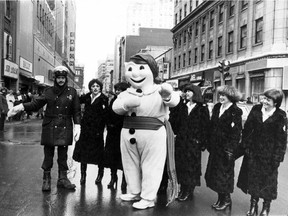 This photo ran in the Gazette Thurs. Jan. 11, 1979 with the caption: Quebec's Bonhomme Carnaval is in Montreal to publicize the forthcoming festivities in the provincial capital, and here he stops traffic at St. Catherine St. and McGill College Ave. with the help of Const. Patrice Comeau. Bonhomme -- in real life Jacques Paradis, president of the 25th Quebec carnival -- is accompanied by the several carnival duchesses. Saturday has been official declared as Quebec Carnival Day in Montreal.