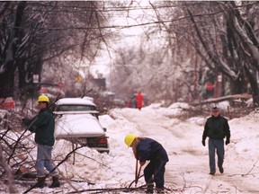 Residents, using hardhats and garden tools, clear branches on Hampton Ave. in N.D.G. on Jan. 10, 1998.
