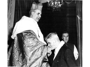 Ernest Léger kisses the ring of his son Paul-Émile Cardinal Léger, on Jan. 29, 1953, after the new cardinal arrived back in Montreal from Rome, via New York. The cardinal then embraced his father. This photo appeared on Page 1 of the Gazette on Jan. 30, 1953.