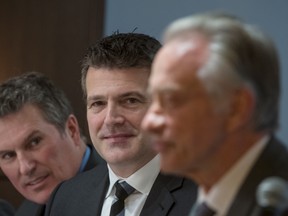 Andrew MacLeod, centre, has been named CEO of Postmedia, succeeding Paul Godfrey, right, who will remain as executive chairman.