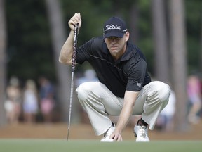 In this June 13, 2014, file photo, Chris Thompson lines up a putt on the 12th hole during the second round of the U.S. Open golf tournament in Pinehurst, N.C.