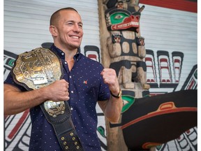 UFC Champion Georges St-Pierre shows off the 2009 Ultimate Fighting Championship title belt that the Canadian Museum of History has acquired and which will become part of the permanent exhibition.