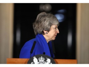 British Prime Minister Theresa May turns away after speaking outside 10 Downing street in London, Wednesday, Jan. 16, 2019. May's government survived a no-confidence vote Wednesday called after May's Brexit deal was overwhelmingly rejected by lawmakers.