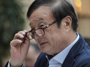 Ren Zhengfei, founder and CEO of Huawei, adjusts his glasses during a round table meeting with the media in Shenzhen city, south China's Guangdong province, Tuesday, Jan. 15, 2019. The founder of network gear and smart phone supplier Huawei Technologies said the tech giant would reject requests from the Chinese government to disclose confidential information about its customers.