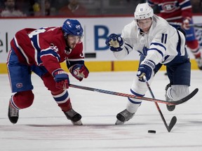 Canadiens' Phillip Danault and Toronto Maple Leafs' Zach Hyman race for the puck in Montreal on Saturday, Feb. 9, 2019.
