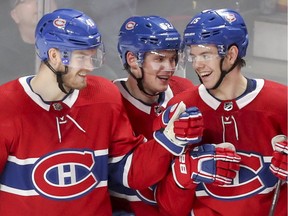 Fellow Finns Joel Armia, left, and Artturi Lehkonen congratulate Montreal Canadiens' Jesperi Kotkaniemi, right, after his goal against the Florida Panthers during third period in Montreal on Jan.15, 2019.