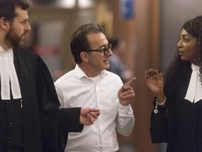 Michel Cadotte and his lawyers at the Montreal courthouse on Jan. 18. A psychologist has testified he suffered a "major depression" in 2013 but was doing better in 2017.