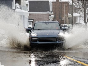 A car splashes through a large puddle on St-Joseph Blvd. in Lachine on Thursday January 24, 2019.