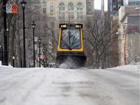Montreal city crews use heavy equipment to break up thick ice on Jan. 29, 2018.