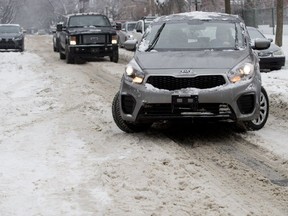 Cars struggle to navigate through ice ruts on Hampton Ave. in Montreal on Monday February 4, 2019.