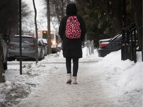 Pedestrian walks along the icy sidewalks on St-Mathieu near Tupper Feb. 6, 2019.