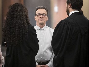 Michel Cadotte speaks with his lawyers during a break in proceedings in court on Thursday February 7, 2019.