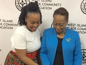 West Island Black Community Association chair Kemba Mitchell, left, cuts celebratory cake with former chair Veronica Johnson to mark the end of mortgage payments on WIBCA's Roxboro office building in 2019.