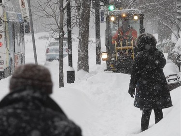 Montreal residents make way for a sidewalk cleaner on Chistophe-Colomb and Jean-Talon Feb. 13, 2019.