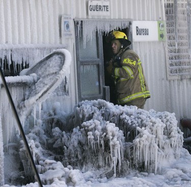 A Laval firefighter/photographer at Serres Sylain Cléroux in Laval Feb. 19, 2019.  Fire destroyed most of a greenhouse and spread to other buildings at Serres Sylvain Cléroux.
