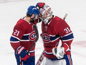 Canadiens goaltender Carey Price is congratulated by teammate Nate Thompson after a 5-1 victory over the Philadelphia Flyers in NHL game at the Bell Centre in Montreal on Thursday, Feb. 21, 2019.