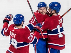 Montreal Canadiens right wing Brendan Gallagher (11) is congratulated by teammates Mike Reilly (28) and Max Domi (13) after his third goal of the game against the Philadelphia Flyers at Montreal's Bell Centre on Thursday February 21, 2019.