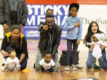 Joubril Disu encourages his 8-month-old son Jamal to go during a baby race in Montreal, February 23, 2019.