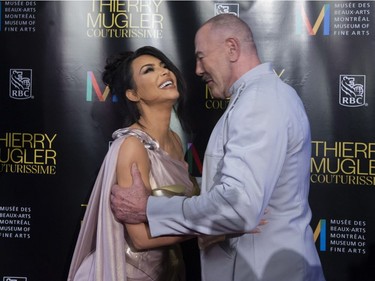 Kim Kardashian West (L) is greeted by Manfred Thierry Mugler as they arrive on the red carpet for the Thierry Mugler exhibition opening at the Montreal Museum of Fine Arts in Montreal, February 25, 2019.
