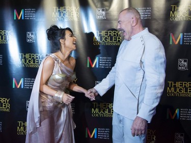 Kim Kardashian West is greeted by Manfred Thierry Mugler as they arrive on the red carpet for the Thierry Mugler exhibition opening at the Montreal Museum of Fine Arts in Montreal on Monday, Feb. 25, 2019.