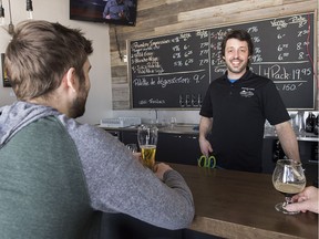 Microbrasserie Trois Lacs Inc. brewer Patrick Sylvestre talks with customers at the brew pub in Vaudreuil-Dorion on Saturday.