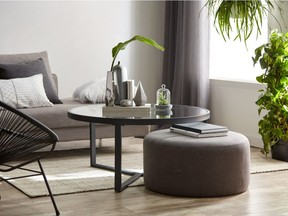 Group similar accessories and layer various tones of colour to create a pleasing looking home. Modern black coffee table $229, Ottoman with handles $149, Bouclair.com