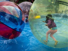 Conditions for happiness are right for young families in the Vaudreuil-Soulanges region. In this photo, a girl plays on a waterwalkerz during a street festival held in Vaudreuil-Dorion last June.