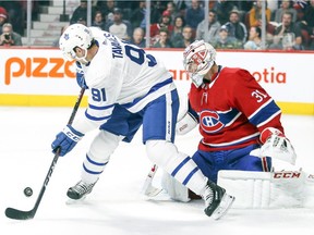 Toronto Maple Leafs' John Tavares deflects a shot in front of Montreal Canadiens' Carey Price at the Bell Centre in Montreal on Sept. 26, 2018.