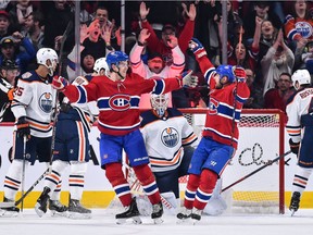The Canadiens’ Jesperi Kotkaniemi (left) celebrates with teammate Tomas Tatar after scoring third-period goal against the Edmonton Oilers at the Bell Centre in Montreal on Sunday, Feb. 3, 2019.
