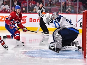 Jonathan Drouin of the Montreal Canadiens shoots the puck past goaltender Connor Hellebuyck of the Winnipeg Jets for a goal in the second period at the Bell Centre in Montreal on Feb. 7, 2019.