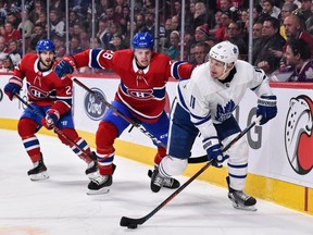 Zach Hyman of the Toronto Maple Leafs carries puck ahead of Mike Reilly of the Montreal Canadiens at the Bell Centre in Montreal on Feb. 9, 2019.