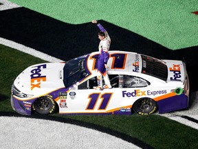 Denny Hamlin celebrates winning the Monster Energy NASCAR Cup Series 61st Annual Daytona 500 at Daytona International Speedway on Sunday, Feb. 17, 2019, in Daytona Beach, Fla.