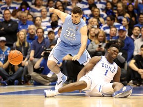 Zion Williamson #1 of the Duke Blue Devils reacts after falling as his shoe breaks against Luke Maye #32 of the North Carolina Tar Heels during their game at Cameron Indoor Stadium on February 20, 2019 in Durham, North Carolina.