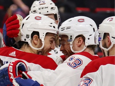 Andrew Shaw #65 of the Montreal Canadiens celebrates his third period goal and hat trick with Max Domi #13 while playing the Detroit Red Wings at Little Caesars Arena on February 26, 2019 in Detroit, Michigan.