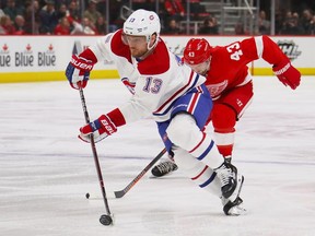 Canadiens' Max Domi skates past Wings' Darren Helm during third-period action in Detroit Tuesday night.