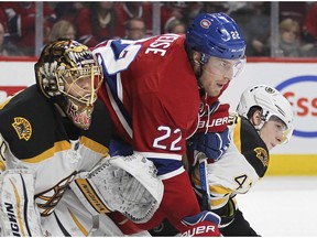 Canadiens' Dale Weise fights for position between Boston Bruins goalie Tuuka Rask and defenceman Torey Krug in Montreal on Dec. 9, 2015.