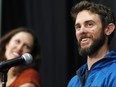 Travis Kauffman responds to questions during a news conference Thursday, Feb. 14, 2019, in Fort Collins, Colo., about his encounter with a mountain lion while running a trail just west of Fort Collins last week. Kaufman's girlfriend, Annie Bierbower, looks on at left. (AP Photo/David Zalubowski)