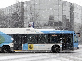 A hybrid bus turns onto de Maisonneuve St. while leaving the Vendome métro station in Montreal in this file photo.