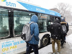 Passengers board a hybrid bus at Vendôme métro station in Montreal on Nov. 27, 2018.