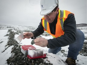 Alliance Magnesium plant manager Remi Belliveau, holds tailing rock with a newly poured magnesium ingot from the old asbestos mine tailings in Danville, Qc, during visit on Tuesday December 18, 2018. Alliance Magnesium is running a pilot project transform mountains of residue from defunct asbestos mines in Danville and Asbestos, Qc. into lucrative magnesium ingots and silica.