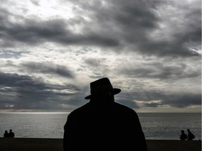 An elderly man looks out towards the Mediterranean Sea near the Promenade des Anglais in the French riviera city of Nice on February 3, 2019.
