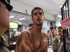 (FILES) In this file photo taken on February 04, 2019 Hakeem al-Araibi, a Bahraini refugee and Australian resident, is escorted to a courtroom in Bangkok. - Thailand has ended the extradition poroceedings against refugee footballer Hakeem al-Araibi on February 11, a prosecutor said.